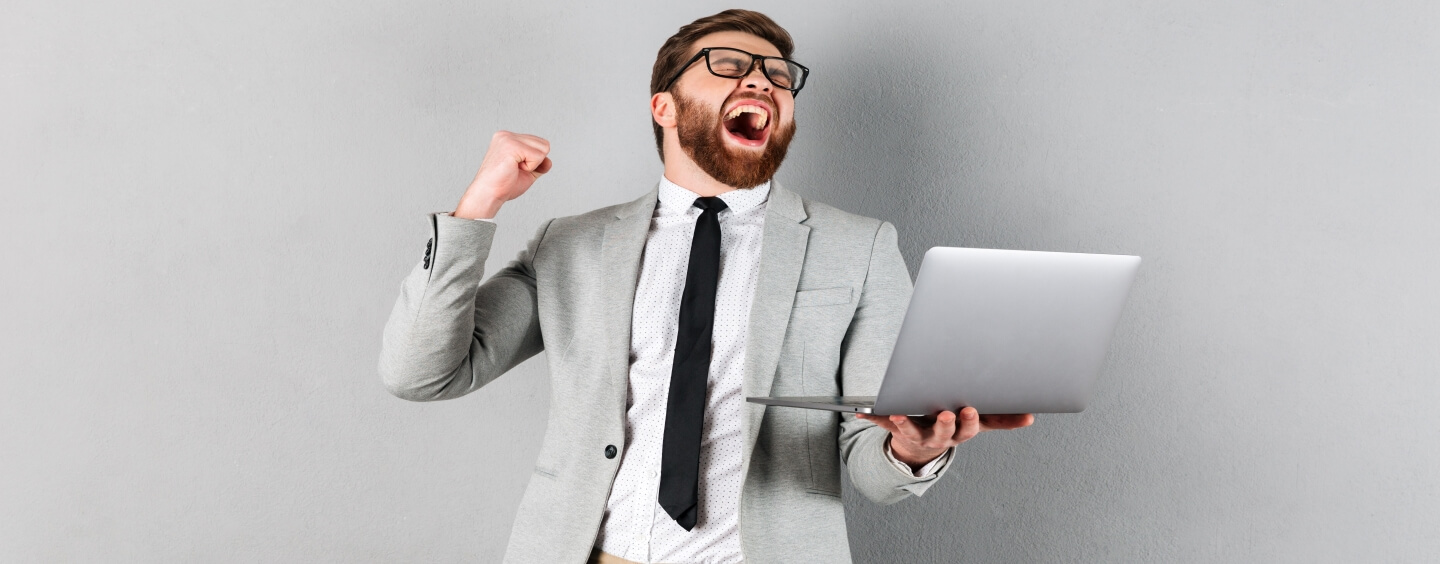 Excited man with laptop